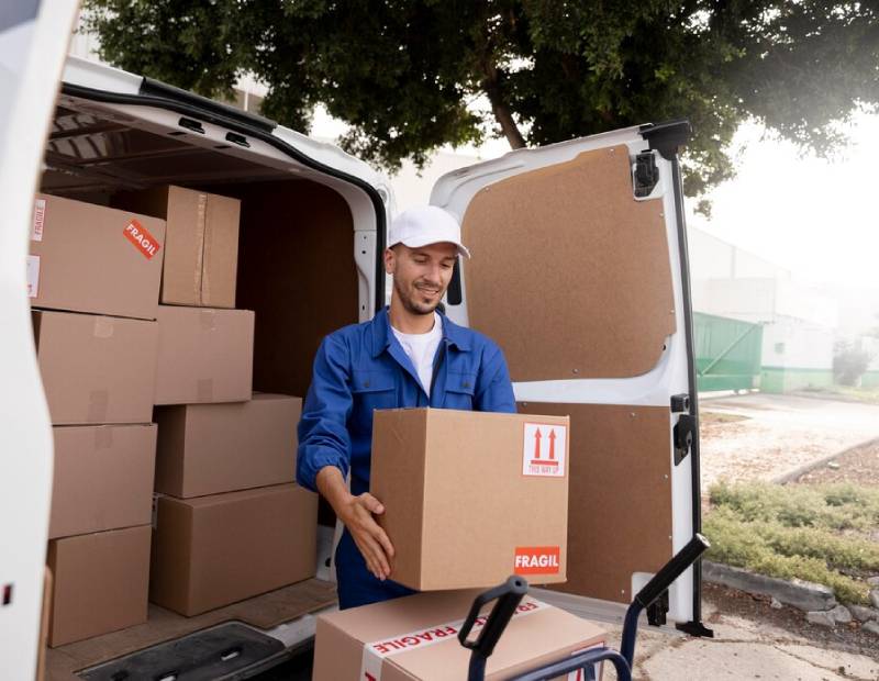 a man assembling the packages packed in cardboard boxes