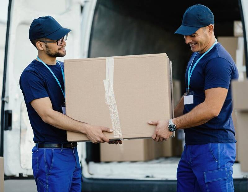 two men moving cardboard box