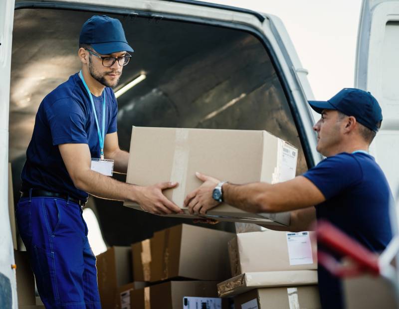 two men moving cardboard box