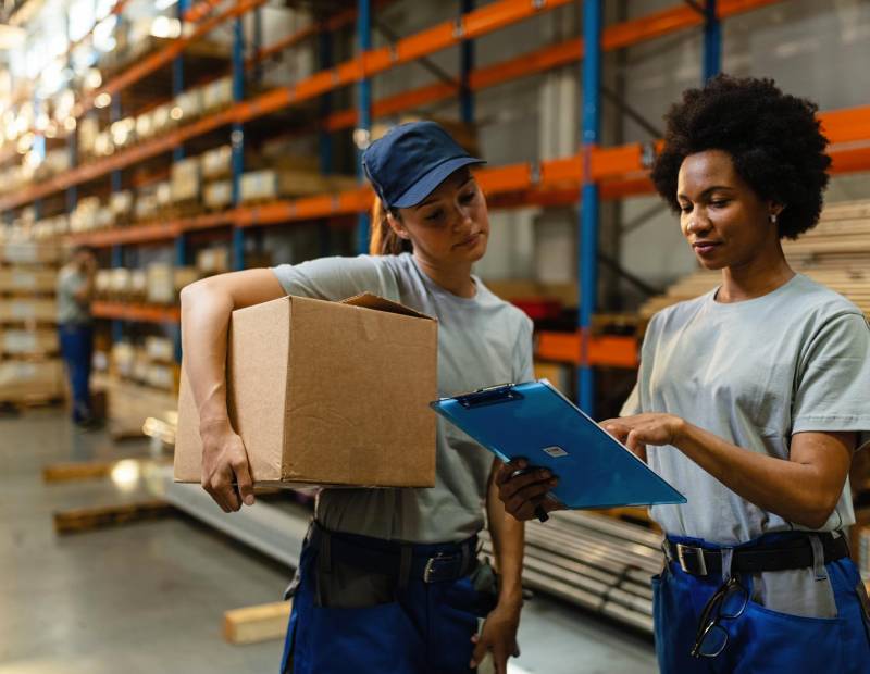 two women talking about self storage in the warehouse